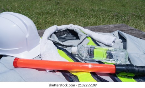 Work Clothes And Water.Workers To Prevent Heat Stroke.Red Stick And Security Guard Uniform.