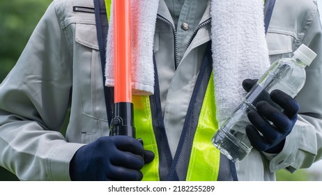 Work Clothes And Water.Workers To Prevent Heat Stroke.Red Stick And Security Guard Uniform.