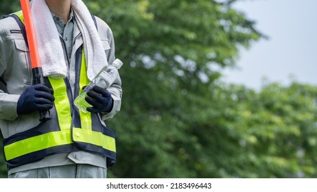 Work Clothes And Water.Workers To Prevent Heat Stroke.Red Stick And Security Guard Uniform.