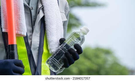 Work Clothes And Water.Workers To Prevent Heat Stroke.Red Stick And Security Guard Uniform.