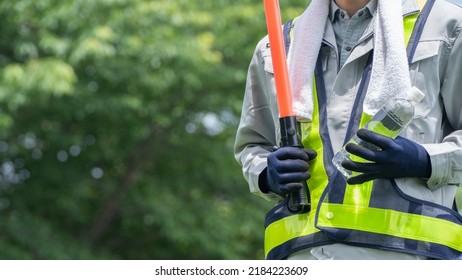 Work Clothes And Water.Workers To Prevent Heat Stroke.Red Stick And Security Guard Uniform.