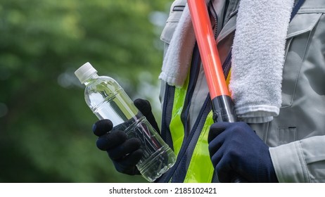 Work Clothes And Water.Workers To Prevent Heat Stroke.Red Stick And Security Guard Uniform.