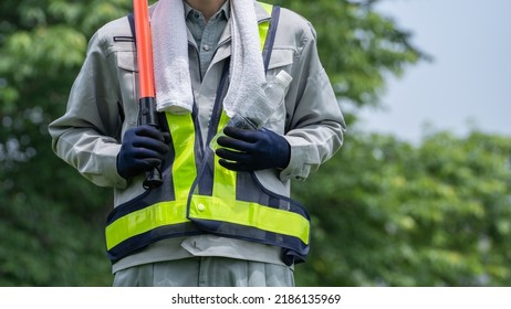 Work Clothes And Water.Workers To Prevent Heat Stroke.Red Stick And Security Guard Uniform.