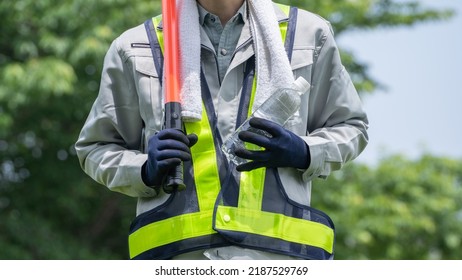 Work Clothes And Water.Workers To Prevent Heat Stroke.Red Stick And Security Guard Uniform.