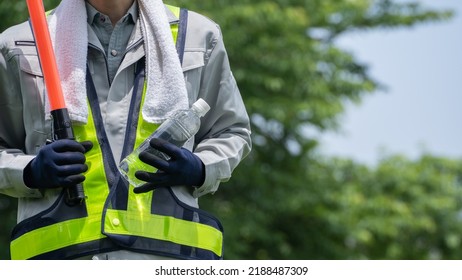 Work Clothes And Water.Workers To Prevent Heat Stroke.Red Stick And Security Guard Uniform.