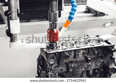 Work of CNC machine for honing to reduce the roughness of the engine cylinder walls. Diamond boring of car details on Computer Numerical Control machine.