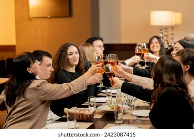 work colleagues are sitting in a restaurant celebrating the conclusion of new deal toast with glasses of wine - Powered by Shutterstock