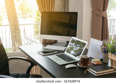 Work Desk Consist Of Laptop, Desktop Books And Coffee Cup