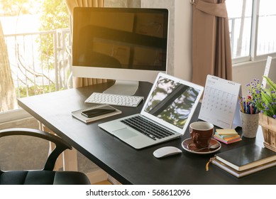 Work Desk Consist Of Laptop, Desktop Books And Coffee Cup