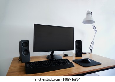 Work desk for digital platforms with computer, audio speakers, mouse and keyboard