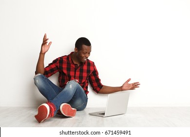 Work Done. Happy Black Man With Laptop. Freelancer Succeeds In Business, At White Studio Background With Crossed Legs