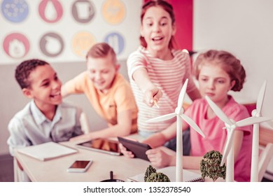 Work during experiment. Group of young curious scientist having class about alternative energy and being cheerful about it - Powered by Shutterstock