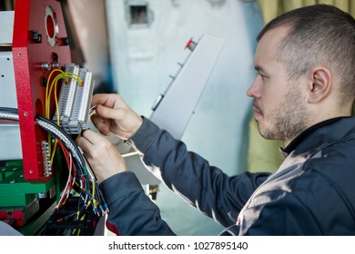 Work of electrician engineer - switching and testing equipment with wires