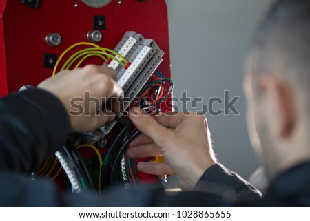 Work of electrician engineer - switching and testing equipment with wires