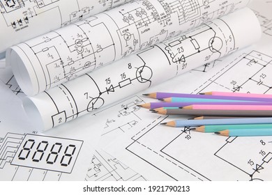 Work of an electronic engineer. Electrical engineering drawings and pencils.