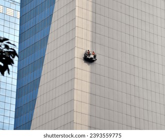Work at the elevation or high rise building using gondola