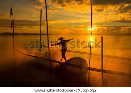 The work of fishermen on the Mekong River raft during the sunrise is a hustling and indigenous way of life in Nong Khai province, opposite to Vientiane Laos.