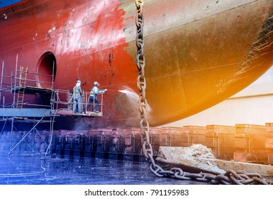 Work in floating dry dock with water jet cleans the shipboard and have movement of people of the ship from sea vegetation before sandblast and paint