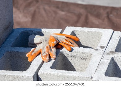 Work gloves on top of concrete block on construction site - Powered by Shutterstock