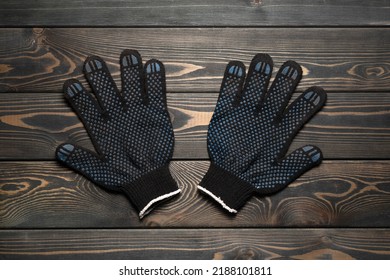 Work Gloves On The Wooden Workbench Flat Lay Background.