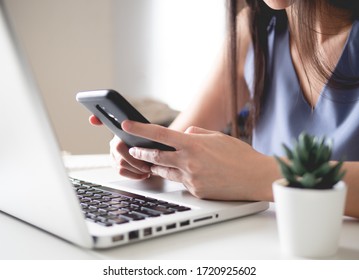 Work From Home Concept With Woman Working On Smart Phone And Laptop Computer.