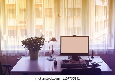 Work at home, empty office table with computer behind the window. 