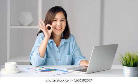 Work From Home, Happy Asian Women Working With Laptop Computer At Home Office And Showing Ok Hand Sign, Asia Female With Okay Hand Sign And Smiling While Woking At Home Office , Girl Study E  Learning