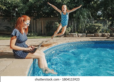 Work From Home With Kids Children. Mother Working On Laptop By Swimming Pool. Child Daughter Jumping In Water. Funny Family Moment. New Normal Workation At Coronavirus Quarantine.