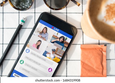 Work From Home With Mobile Video Conference Collaboration With Colleagues.live Streaming Meeting.protect Risk Of Being Exposed To Coronavirus (covid-19).top View Mobile With Coffee On Table