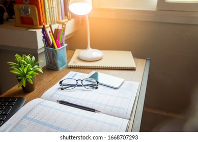 Work Home Office Concept. Planner And Organizer Plan Timetable, Meeting Agenda, Daily Appointment And Organization. Desktop Calendar, Diary, Tablet, Smartphone And Eyeglasses Place On Wooden Desk.