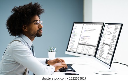 Work From Home On Multiple Computer Screen. African Programmer