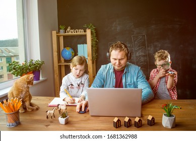 Work From Home. School Home Education During Quarantine. Father Works With Children Boy And Girl On Table.