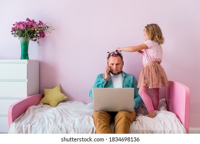 Work From Home. Stress To Work With Family Around. Parent At Home Office Because Of Covid 19. Fathers Day With Daughter At Home. Cute Girl Putting On Make Up On Her Father. Pink Room Interior.