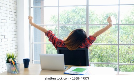 Work from home, Stretch for relax, Young asian woman stretching body while working with laptop computer at her desk home office, Back of female student raised arms take rest from online education - Shutterstock ID 1688449579