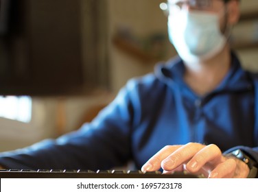 Work From Home, Tele Work, Teleworing COVID-19 Concept. Worker Man In Medical Mask Using Notebook Computer Working For Social Distancing Meeting Online With Social Media Application