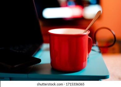 Work From Home Workspace Set-up During Coronavirus Pandemic. Red Mug, Laptop,portable Hard Disk And Lap Desk.