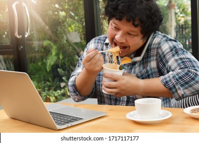 Work From Home,Businessman Working Remotely From Home. Using Computer And Eating Cup Noodle. Distance Learning Online Education And Work