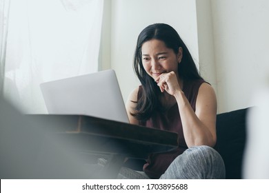 work from home.using computer.hand typing keyboard laptop online chatting search form internet while working sitting on sofa.concept for technology device contact communication business people