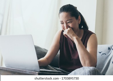 work from home.using computer.hand typing keyboard laptop online chatting search form internet while working sitting on sofa.concept for technology device contact communication business people - Shutterstock ID 1703895730