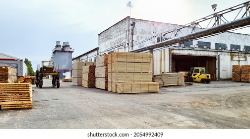 Work in an industrial warehouse. Forklift and tractor at industrial lumber warehouse - Shutterstock ID 2054992409