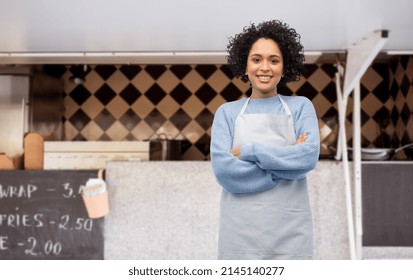 work, job and people concept - happy smiling woman in apron over food truck on street background - Powered by Shutterstock