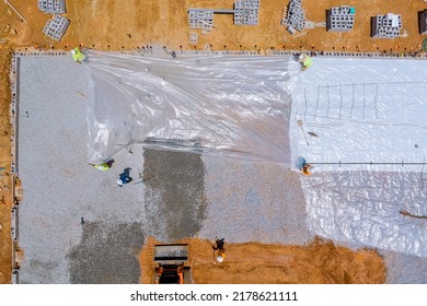 Work Leveling Gravel On Construction Site With An Excavator Before Preparing Pouring Concrete In The Building Foundation