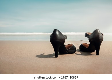 Work Life Balance Concept. Business Woman Take Off Working Shoes And Leave It On The Sand Beach For Walk Into The Sea. Quit A Job, Office Outing Or Summer Vacation. Low Angle View