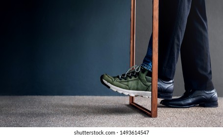 Work Life Balance Concept. Challenging To Change. Low Section Of Businessman Steps Passing A Wooden Frame. Half Is A Formal Dress And Other Side Is A Casual Traveling Shoes 