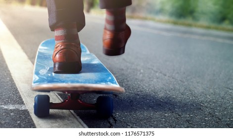Work Life Balance Concept. Low Section of Businessman Balancing his Body on Skateboard in Park