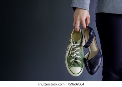 Work Life Balance Concept, present by Business Working Woman holding a High Heal and Sneaker Shoes, Croped image with Copy Space 