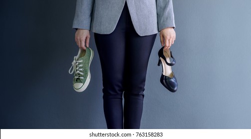 Work Life Balance Concept, present by Business Working Woman holding a High Heal and Sneaker Shoes, Croped image with Copy Space 