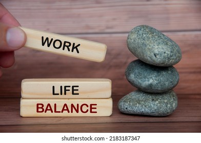 Work Life Balance Text On Wooden Blocks With Rocks And Wooden Cover Background. New Ways Of Working Concept