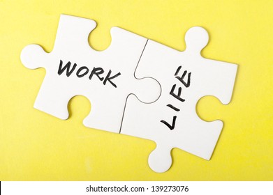 Work and life words written on two pieces of jigsaw puzzle