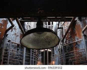 Work Light On Abandoned Factory Floor Of Historic Steel Mill